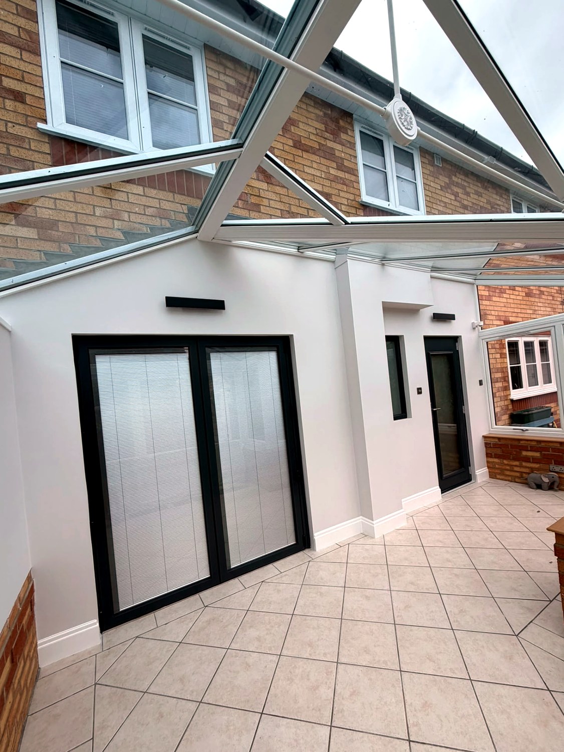 Interior roof and French door detail inside a newly fitted white UPVC conservatory in Langtoft