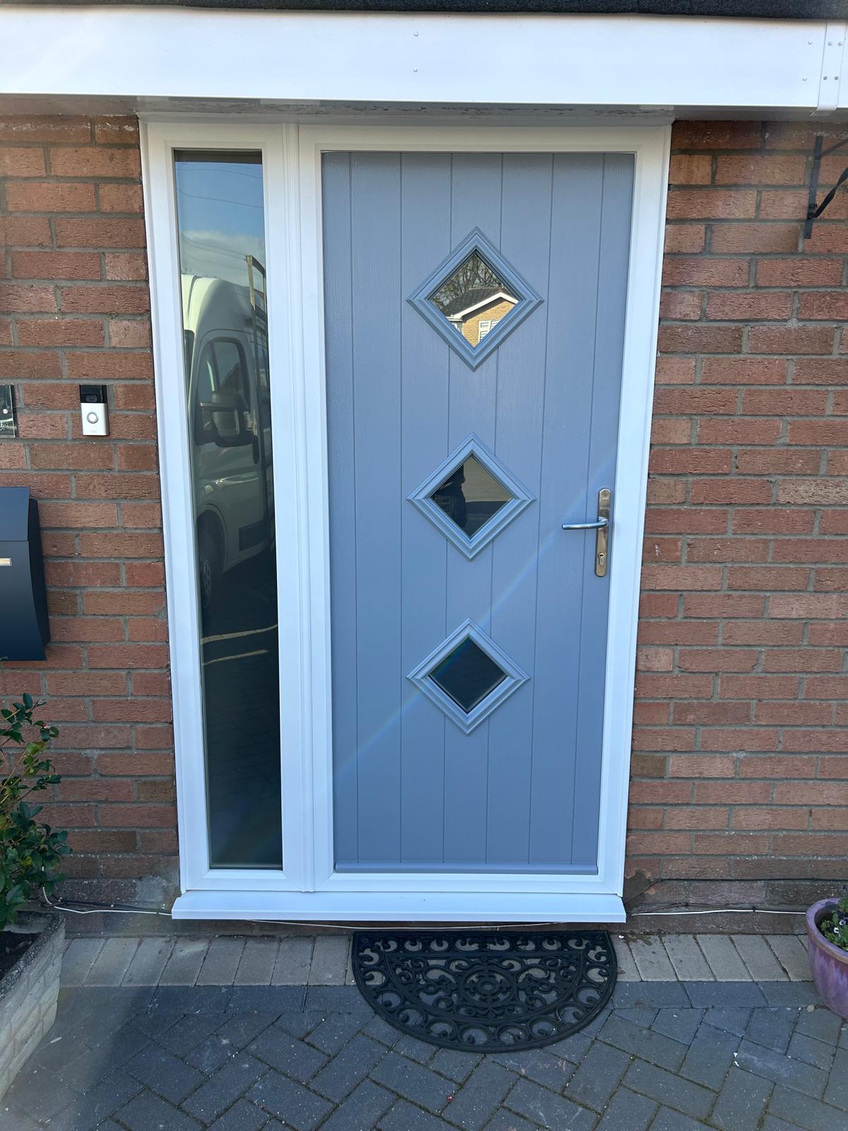 Blue grey cottage style composite front door with three diamond lights and a white framed sidelight in Bourne