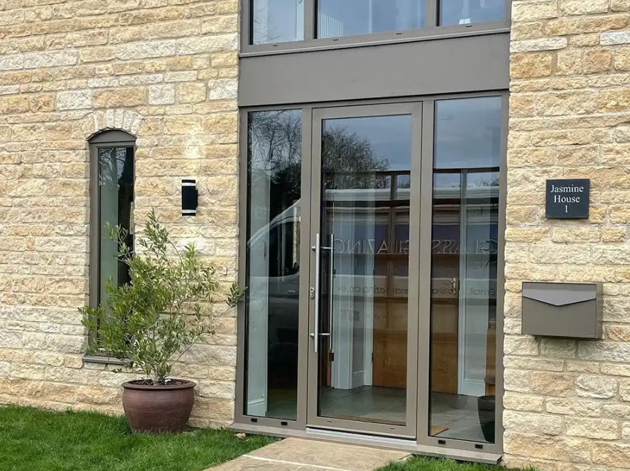 Anthracite aluminium entrance door with glazed side panels at Jasmine House, Rutland