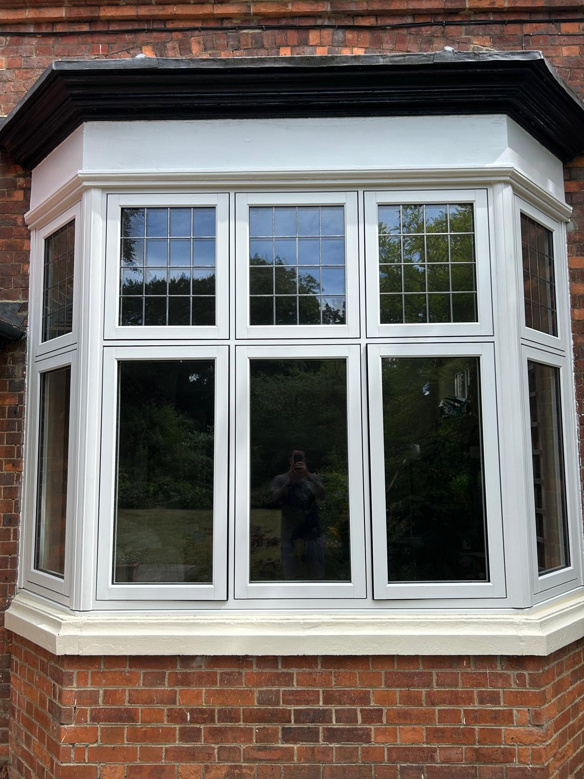 White leaded bay window with Georgian bar toplights fitted to a red brick Victorian house in Stamford