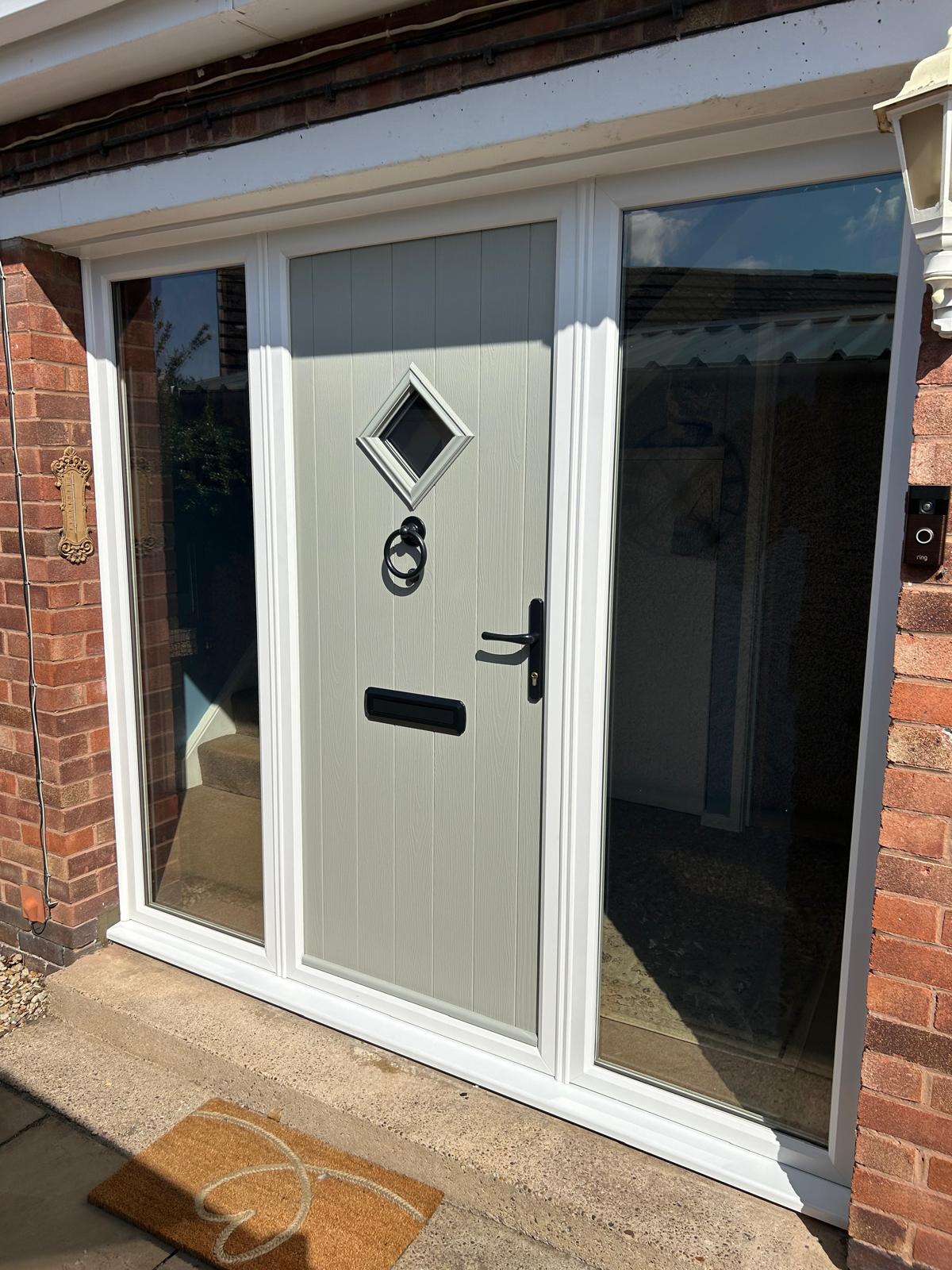 Pale grey vertical board composite front door with diamond light and two full-height glazed sidelights in Rutland