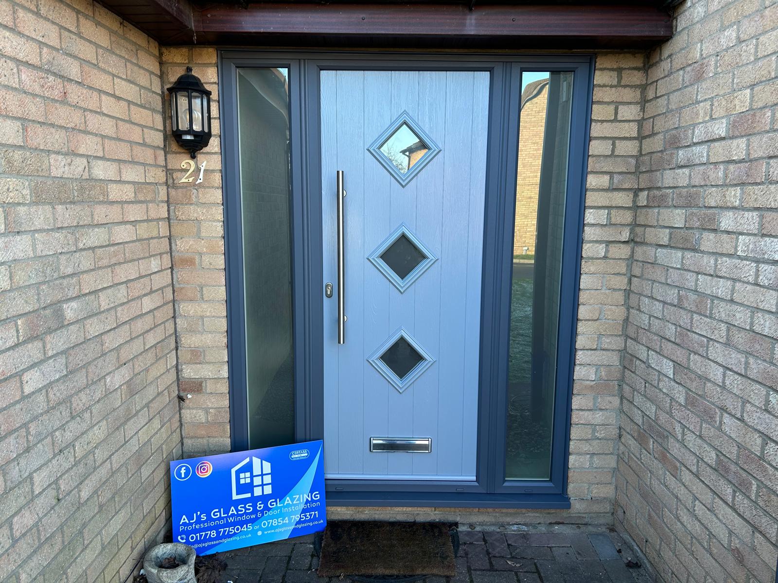 Duck egg blue composite front door with three diamond lights and anthracite grey sidelights in Bourne