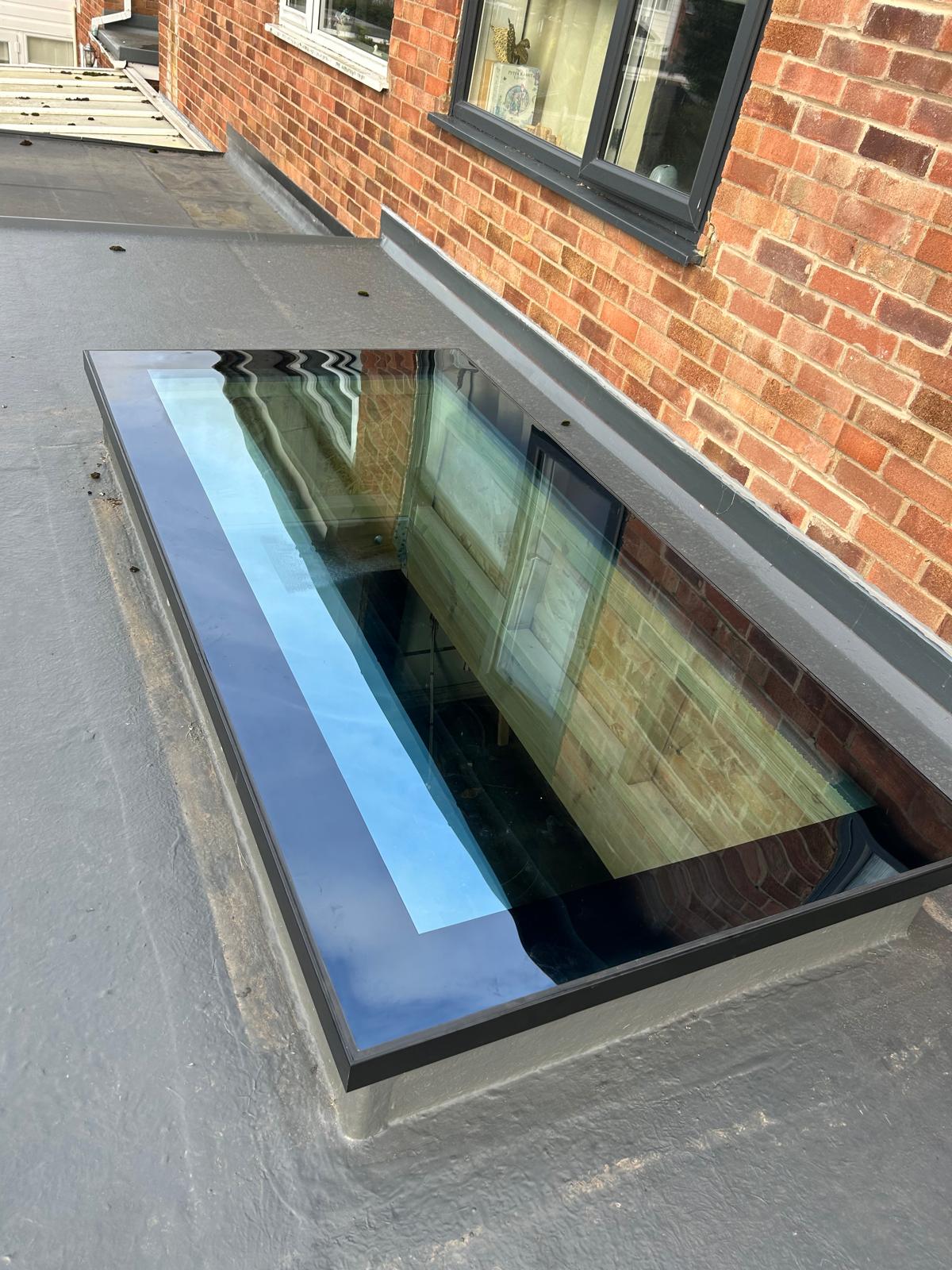 Flush fitted flat glass rooflight installed in a grey flat roof extension in Peterborough